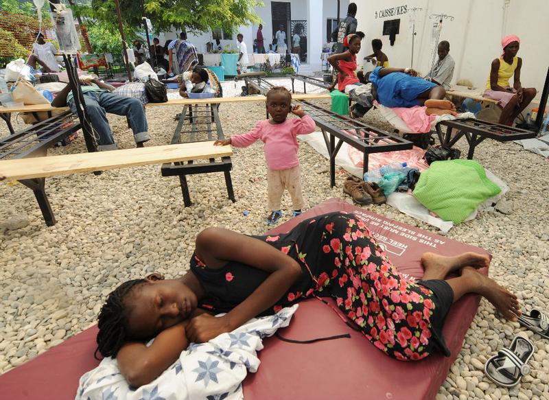 Sick victims and families wait for treatment at St. Nicolas Hospital in St. Marc, north of Port-au-Prince.